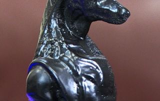 A carved wooden knight chess piece with an Egyptian theme